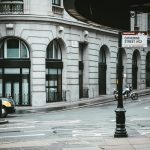 yellow taxi cab on road near building during daytime