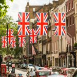 a british flag hanging over a city street